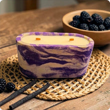 Load image into Gallery viewer, Purple and white marbled concrete candle on a woven mat with black raspberries and vanilla beans.