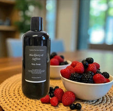 Load image into Gallery viewer, Bottle of Blackberry & Saffron Mop Soap on a table with bowls of berries.