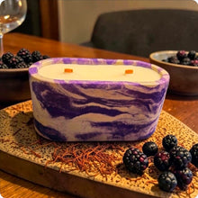 Load image into Gallery viewer, Marbled purple and white concrete candle on a wooden surface with blackberries and saffron.