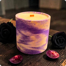Load image into Gallery viewer, Purple and white marbled candle on a dark surface with black roses and a halved purple plum fruit.