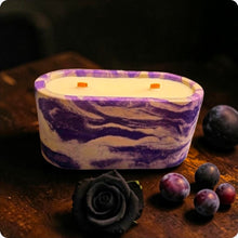 Load image into Gallery viewer, Marbled purple and white candle on a dark surface with plums and a black rose.
