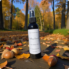 Load image into Gallery viewer, Bottle of 'Falling Leaves' spray on a leaf-covered ground with trees in the background