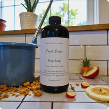 Load image into Gallery viewer, Bottle of Fruit Loops Mop Soap on a kitchen counter with fruit and cleaning supplies.