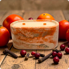 Load image into Gallery viewer, Candle in a decorative concrete container with cranberries, and cloves on a wooden surface