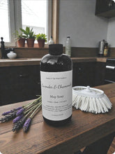 Load image into Gallery viewer, Bottle of mop soap with lavender and chamomile on a wooden surface in a kitchen setting.