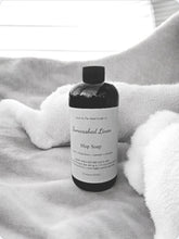 Load image into Gallery viewer, Bottle of Sunwashed Linen Mop Soap on a textured surface with a towel