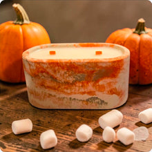 Load image into Gallery viewer, Concrete candle on a wooden surface with pumpkins and marshmallows.