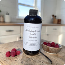 Load image into Gallery viewer, Bottle of Black Raspberry &amp; Vanilla Mop Soap on a wooden surface with raspberries and vanilla beans.
