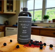 Load image into Gallery viewer, Bottle of Candle In The Wind Candle soap on a wooden surface with blackberries in a kitchen setting
