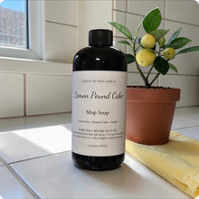 Load image into Gallery viewer, Bottle of Lemon Pound Cake Mop Soap on a tiled surface with a plant and towel in the background.
