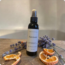 Load image into Gallery viewer, Spray bottle labeled 'Narcissist' on a wooden surface with dried oranges and lavender.
