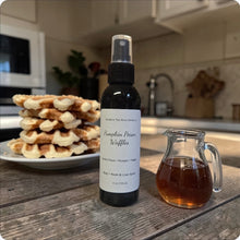 Load image into Gallery viewer, Bottle of pumpkin pecan waffles-scented room spray on a kitchen counter with waffles and syrup.
