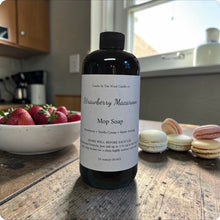 Load image into Gallery viewer, Bottle of Strawberry Macaron Mop Soap on a kitchen counter with strawberries and macarons.
