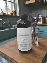 Load image into Gallery viewer, Bottle of Vanilla Sugar Mop Soap on a kitchen counter with lavender in the background
