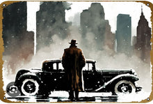 Load image into Gallery viewer, Man in a trench coat standing next to an old car in a snowy cityscape
